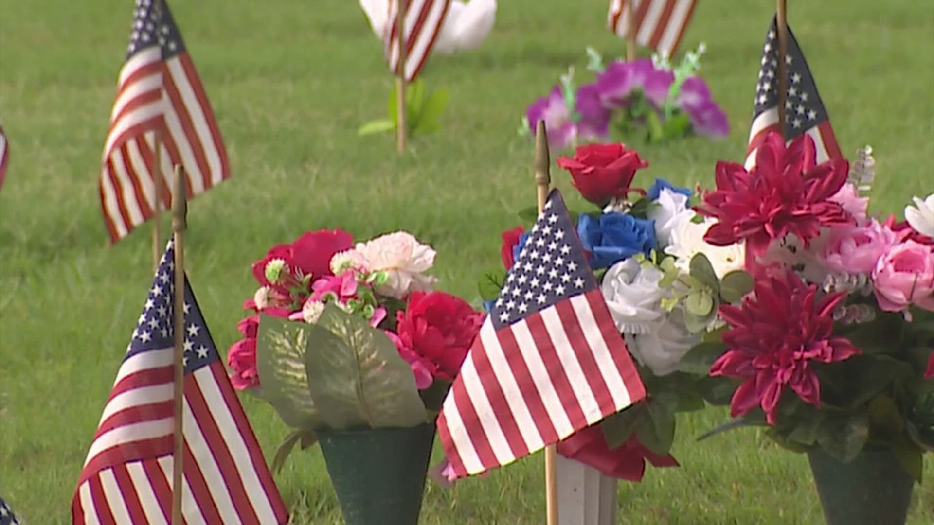 Volunteers plant flags at Houston National Cemetery for Memorial Day